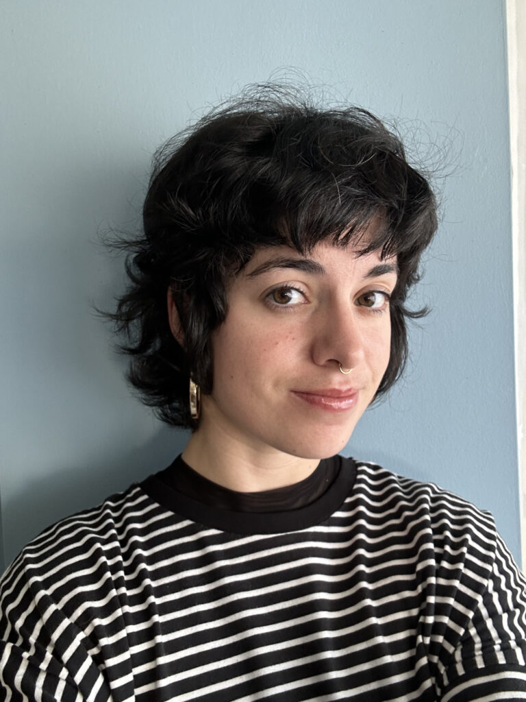 A passport-sized photo of the postdoctoral researcher Marta Brescia. She is the classic Mediterranean woman with black, short hair, brown eyes, and is wearing a striped shirt.